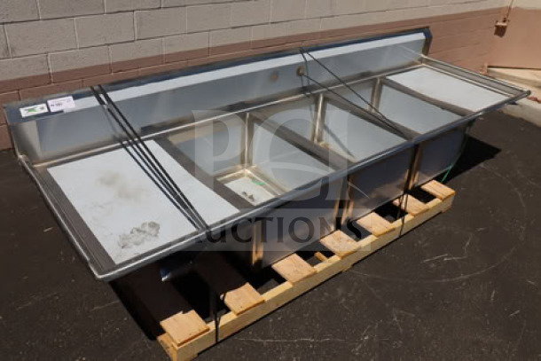 Regency Spec Line 600S32028224 112" three-compartment commercial sink with two 24" drainboards, minor scratches visible.