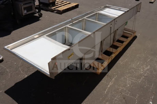 Regency Spec Line 600S32028224 112" three-compartment commercial sink with two 24" drainboards, some minor scratches and dents.