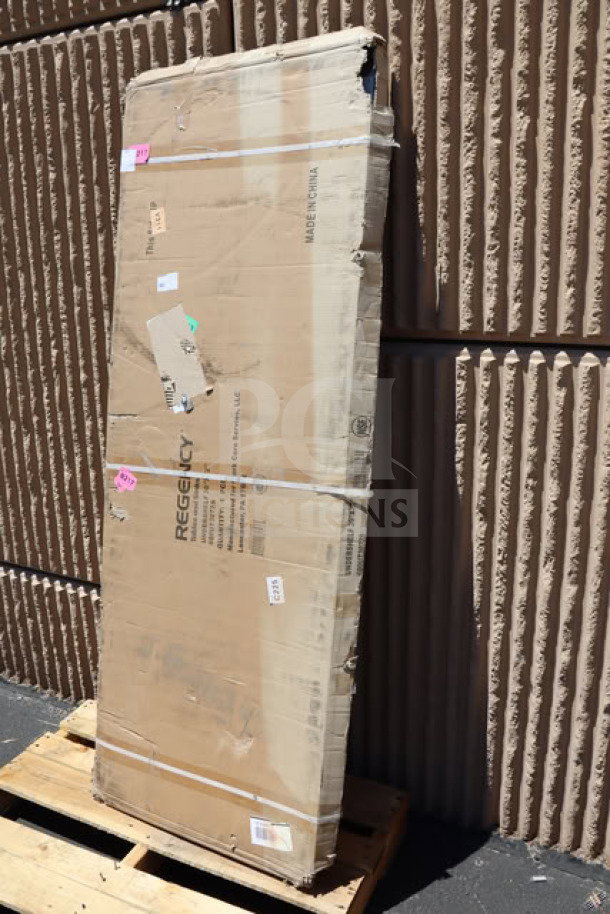 Brand new Regency 600UT3072S adjustable stainless steel work table undershelf, 18-gauge, for 30" x 72" tables. Damaged packaging visible.