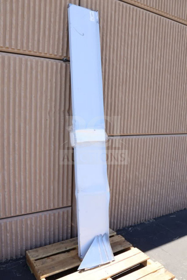 Brand new Regency Space Solutions 600WS1296HD gray locker, unassembled, in packaging on pallet, showing mild scratches.