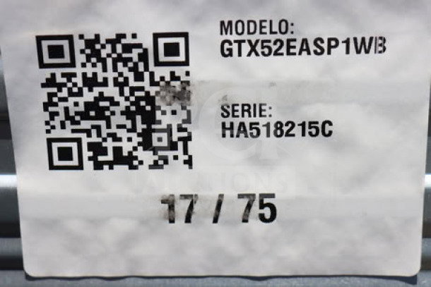 QR code and labels on GE GTX52EASPWB 6.2 cu. ft. front load electric dryer. S/N: HA518215C. Model number visible.