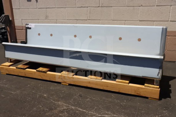 Regency 600HSMS1872 wall-mounted 72"x17.5" hand sink for 3 faucets, new condition, shown on wooden pallet.