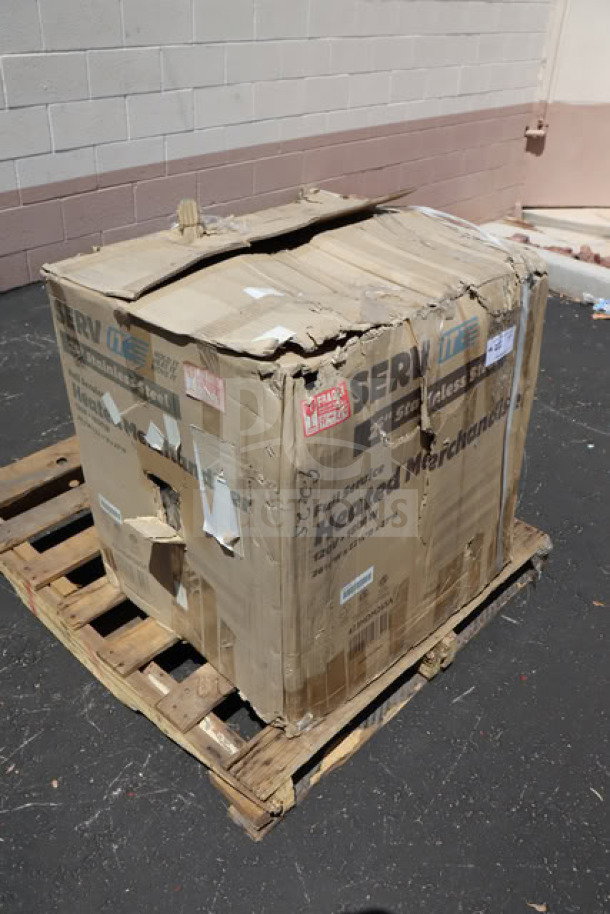 Damaged packaging of ServIt HDM-26 heated display case. Item appears damaged in transit. Box on wooden pallet outdoors.