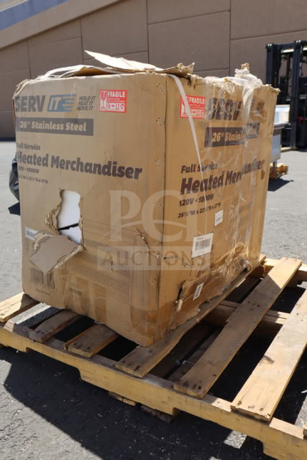 New ServIt HDM-26 heated display case on pallet. Box shows damage; labeled 26" stainless steel, 120V, 1800W.