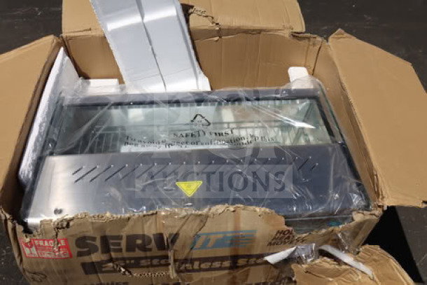 Brand new ServIt HDM-26 heated display case, 26", 3 shelves, in damaged packaging, 120V, 1800W, transit damage visible.