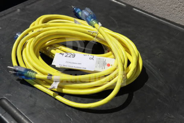 Brand new yellow extension cord set, 15A 125V 1875W. Suitable for outdoor use. Includes tags indicating model and specifications.