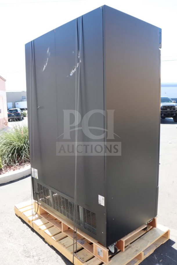 Avantco GDC-49-HC 53" black merchandiser fridge with swing glass doors on pallet. Shows exterior scratching and denting.