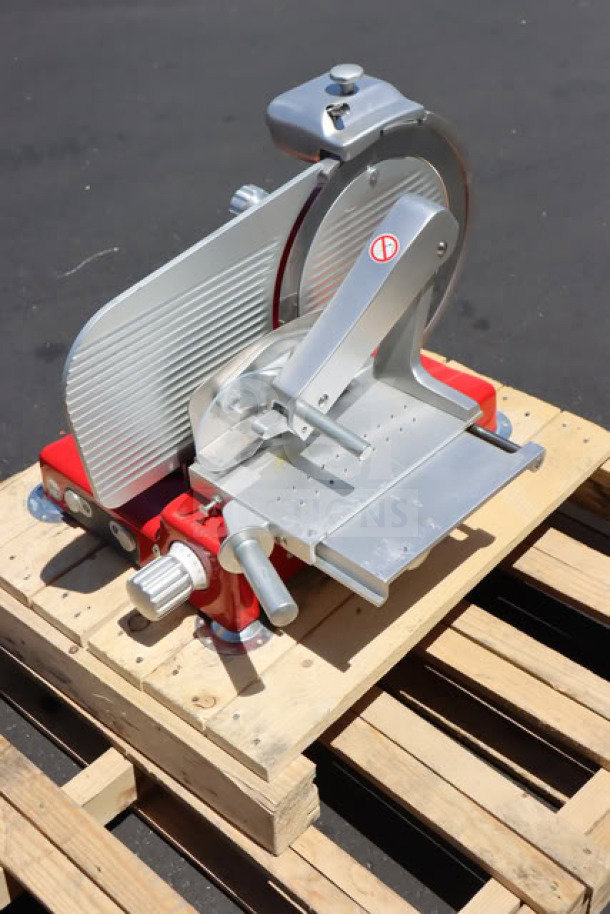 Sirman Mantegna 350 BS manual meat slicer, red, 14" blade, heavy-duty, 120V, slightly scratched, on wooden pallet.