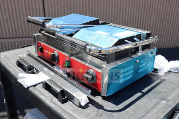 Brand new Avantco PG400GS commercial dual panini grill with grooved top and smooth bottom plates, 19 5/8" x 9 1/8" surface.