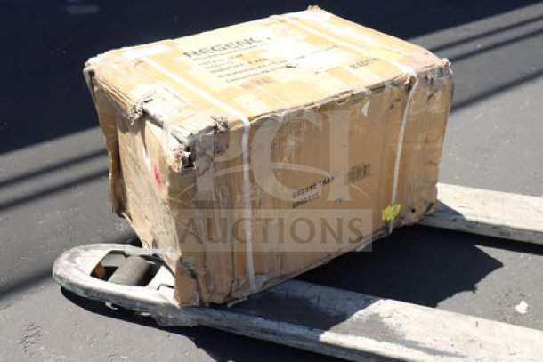 Regency 600GT15 grease trap with damaged packaging on pallet jack, model 600GT15, PDI certified.