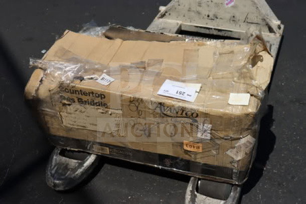 Avantco CAG-15-TG 15" gas griddle box, 35,000 BTU, new with damaged packaging. Labels visible on worn cardboard.