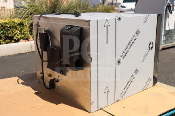Cadco Arianna XAF-133 countertop convection oven, 4-shelf, new condition, protective wrap intact, heavy-duty manual controls.
