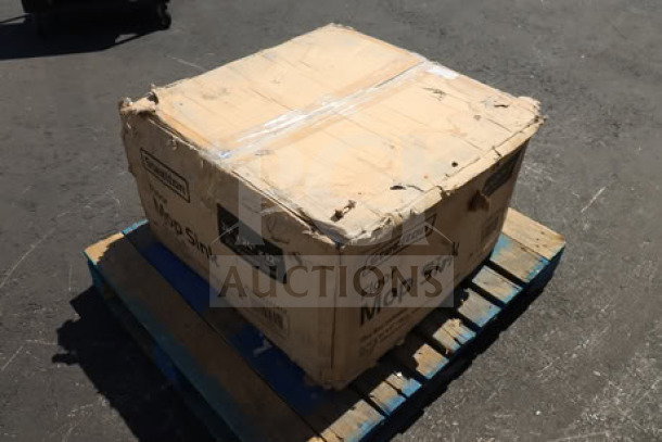 Steelton stainless steel mop sink, model 522MS242412, in damaged packaging on a pallet.