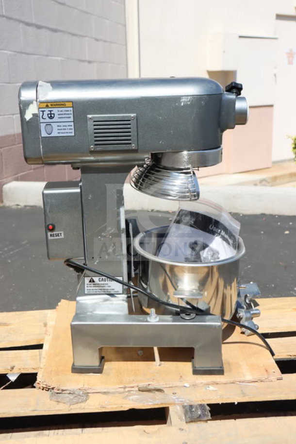 Avantco MX10H 10 Qt. Planetary Stand Mixer, new, with guard and accessories, 120V, 3/4 hp, on pallet, visible warnings.