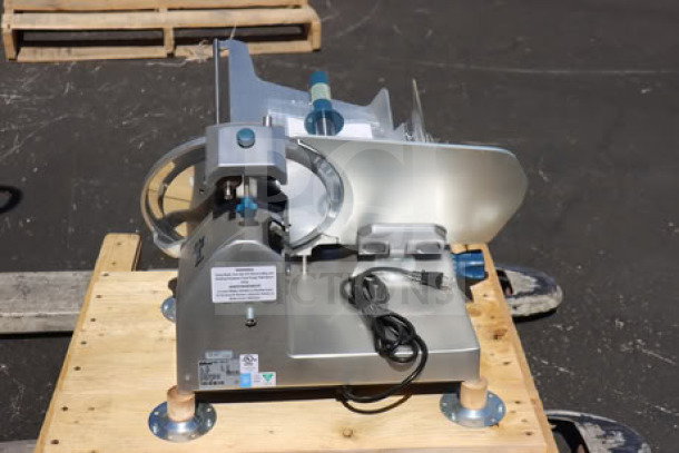 Brand new Edlund EDV-12 12" manual meat slicer, medium-duty, 1/2 hp, 115V. Minor scratches and dents visible.