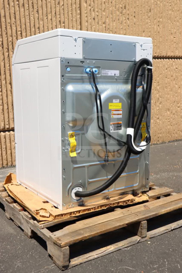 Brand new Speed Queen FF7012WN front load washer, 3.5 cu. ft., right hinged, on a wooden pallet, with visible tags.