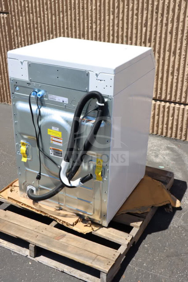 Brand new Speed Queen FF7012WN 3.5 cu. ft. front load washer on pallet, showing rear connections and labels.