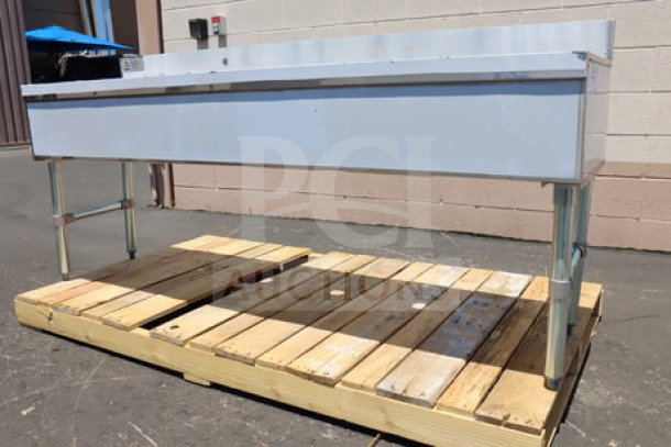Advance Tabco SLB-64C 72" x 18" four-compartment bar sink with two 12" drainboards, new condition, on a wood pallet.