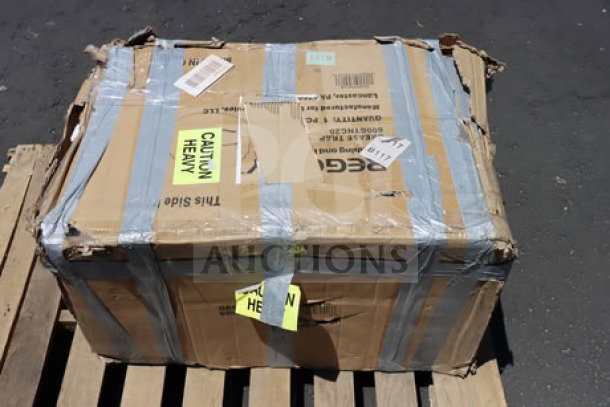 Brand new Regency 40 lb. 20 GPM grease trap, model 600GTNC20, in damaged original packaging on pallet.