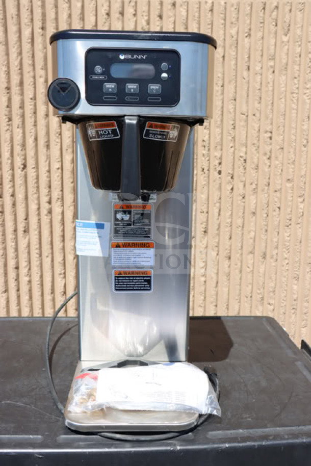 Bunn 53100.0001 BrewWISE ICB-DV stainless steel coffee brewer, dual voltage, minor scratches, warning labels visible.
