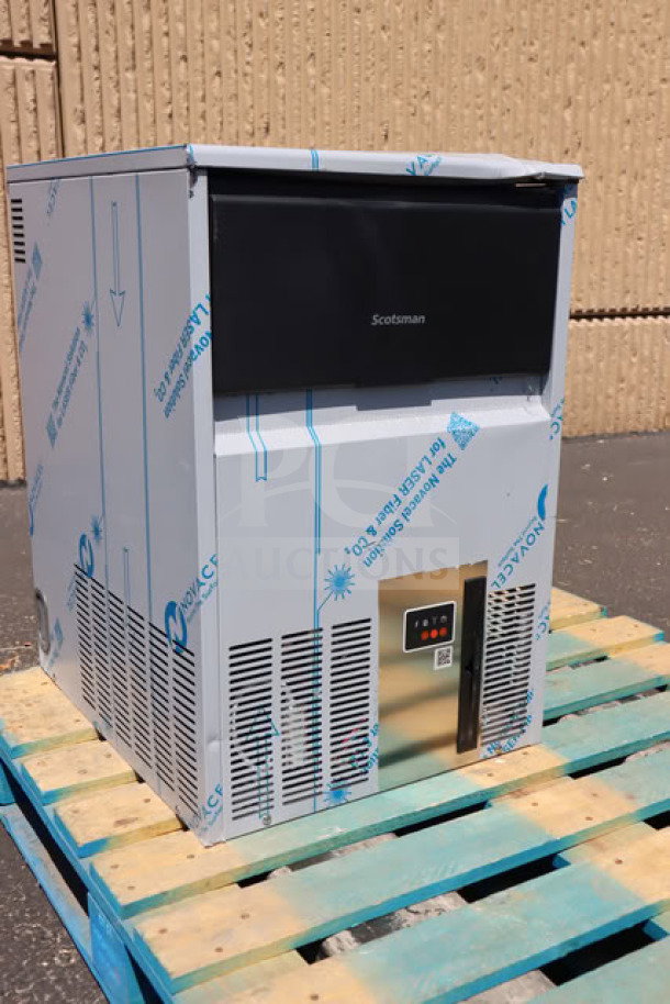 BRAND NEW Scotsman UC0918GAX-1A 18" air-cooled undercounter ice machine on a pallet, with visible protective wrapping, minor scratches.