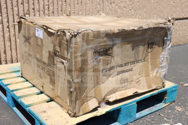 Damaged packaging for Regency 600SM242412 29" stainless steel mop sink. Original box with visible dents and scratches.