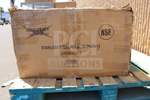 Cardboard box labeled "Regency 600SM242412 Stainless Steel Mop Sink 24x24x12" on a pallet. Box shows signs of damage.
