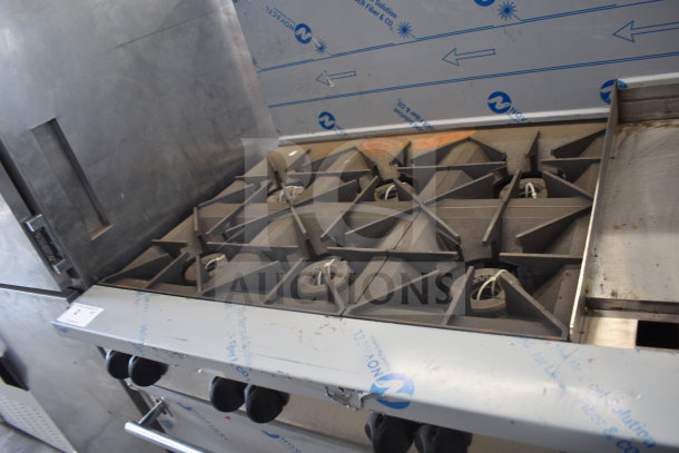 Vulcan 72SS-6B36GTN commercial range; 6 burners, flat top griddle, 2 ovens, backsplash. Natural gas, industrial setup.