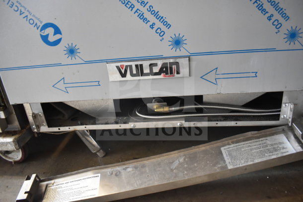 Vulcan 72SS-6B36GTN commercial gas range featuring 6 burners, flat top griddle, 2 ovens, and backsplash. Visible Vulcan logo.
