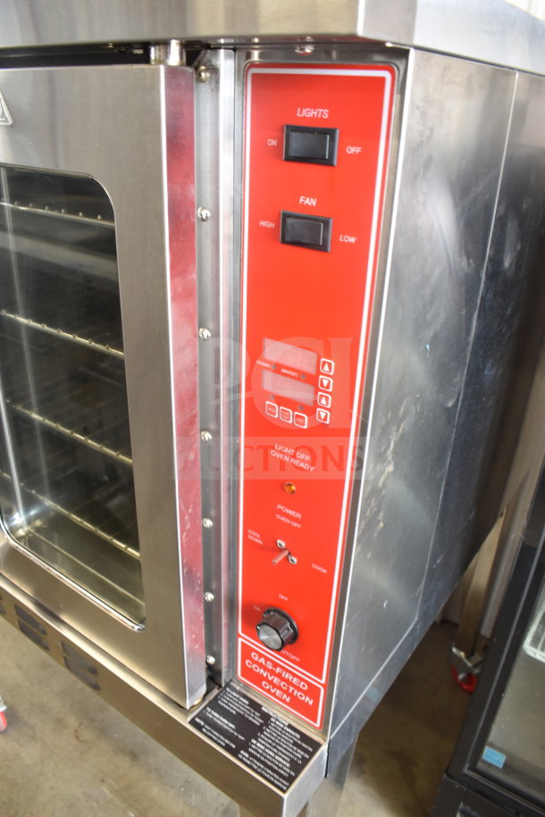 Migali commercial gas convection oven with view-through doors, metal legs on casters, control panel, and power indicators.
