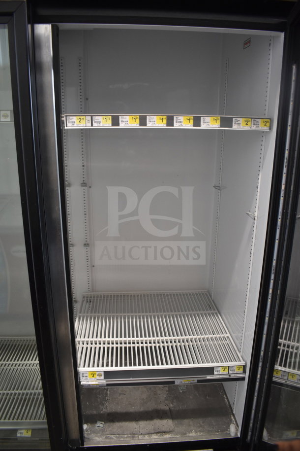 2017 True GDM-72-HC commercial 3-door cooler merchandiser, 115V, 1 phase, tested working, white interior with adjustable shelving.