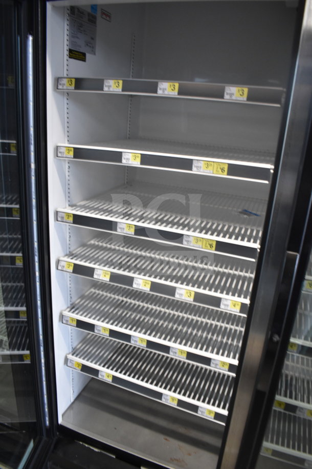 2017 True GDM-72-HC commercial 3-door cooler, tested, working; 115 volts, 1 phase; visible product tags on shelves.