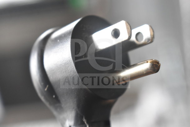 Close-up of black power plug for 2019 True GDM-23F-HC Commercial Freezer, showing prongs and rounded tip detail.