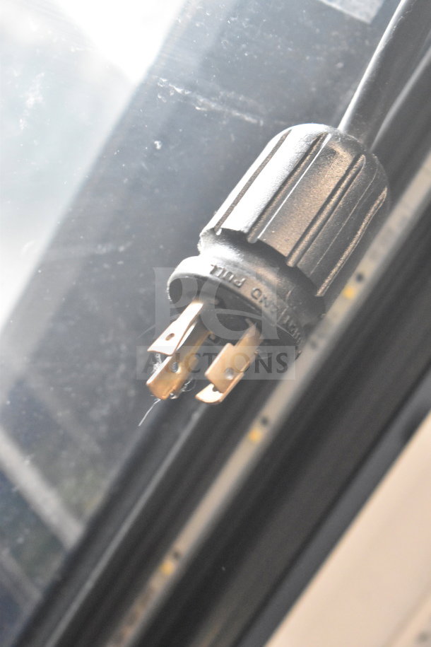 Close-up of the True GDM-72F-HC freezer merchandiser plug, showing a 3-prong electrical connector.