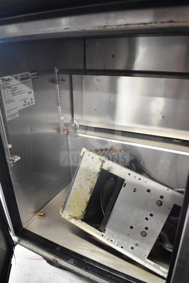 True TWT-48 2 Door Work Top Cooler, 115V, 1 Phase. Interior shows wear, with visible tags listing model and specs.