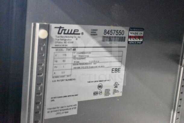 True TWT-48 Commercial Work Top Cooler label, 115 volts, 1 phase, serial 8457550, Made in USA, model details visible.