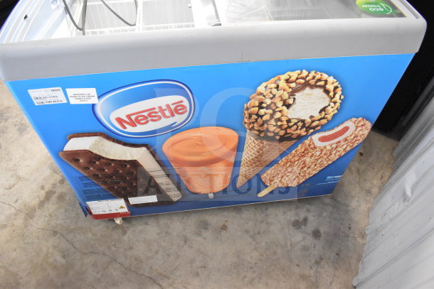 AHT RIO S 100 commercial chest freezer with Nestle branding, 115 volts, 1 phase. Features ice cream graphics, AHT and property labels visible.