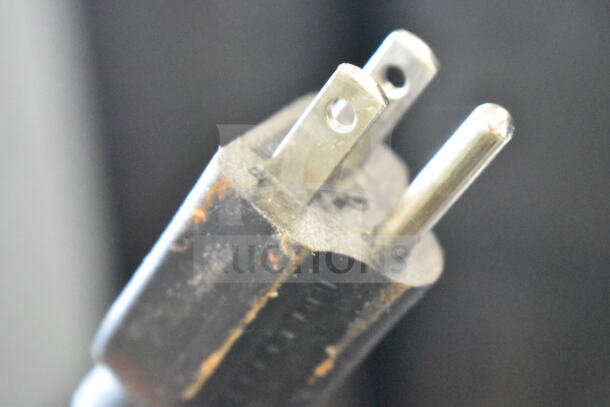 Avantco 177RCB60 electric rice cooker plug, showing standard three-prong configuration. Visible wear on edges.