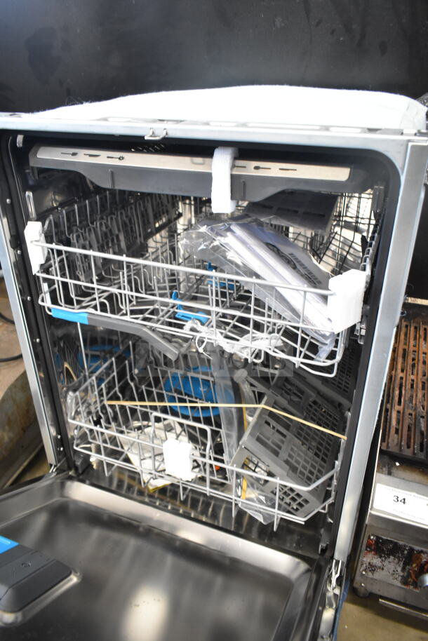 Frigidaire undercounter dishwasher, stainless steel interior, dual rack system, new condition with protective packaging intact.