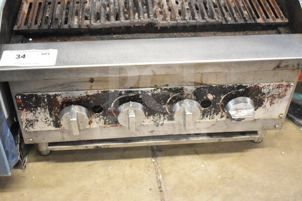 Vollrath Commercial Charbroiler Grill, gas-powered, worn condition, three control knobs, stainless steel body, model number visible.