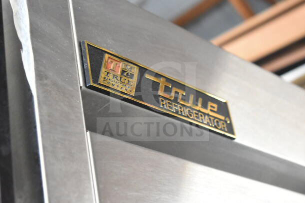 2016 True T-35 Commercial 2 Door Reach In Cooler, model T-35, 115V, 1 Phase. Close-up of manufacturer's logo.