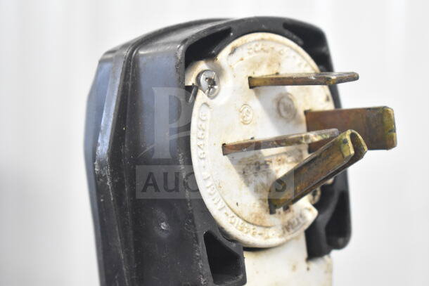 Close-up of Garland CXPB12 grill plug, showing three-phase connector. Some wear visible, suitable for 208-240 volts.