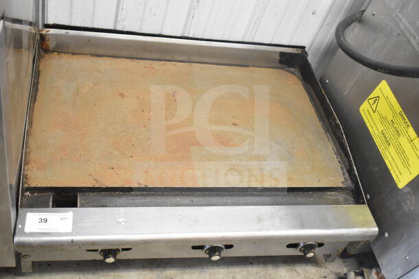 Radiance Commercial Countertop Flat Top Griddle in used condition, with three control knobs and visible wear. Label indicates electrical caution.