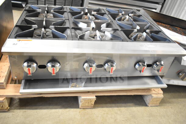 Commercial countertop gas-powered 6 burner range with stainless steel finish, control knobs, and sturdy design.