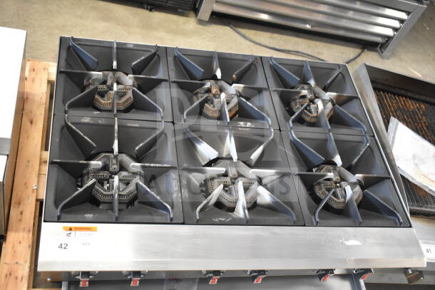 Commercial countertop gas-powered 6 burner range in good condition, featuring durable cast iron grates and control knobs.