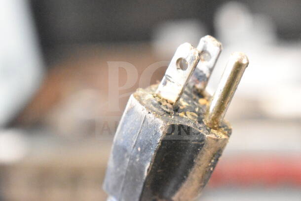 Close-up of a plug for AvaToast T140 Commercial Conveyor Toaster Oven, 120 Volts, showing wear and markings.