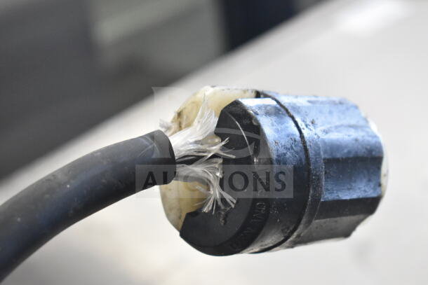 Close-up view of a frayed power cable attached to a Hoshizaki KM-900MRH ice machine head. Visible wear on connector.