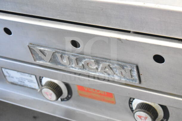 Vulcan commercial gas-powered flat top griddle with undershelf; features metal control knobs, branded label, used condition.