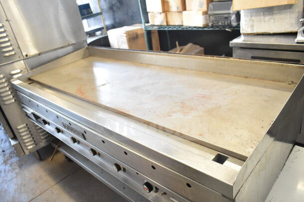 Vulcan commercial gas-powered flat top griddle with under shelf, features stainless steel construction and temperature controls.