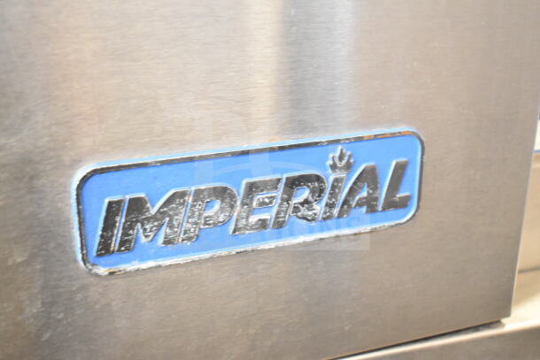Imperial commercial convection oven, metal surface with logo. Features view-through and solid door, thermostatic controls.